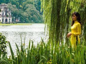 Beautiful Woman with Long Hair Wears Yellow Satin In Front of Tortoise Pagoda