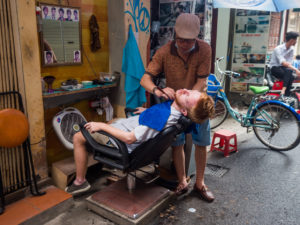 Man Being Shaved By Barber On Streets of Hanoi
