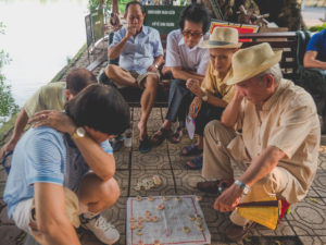 Men Playing A Game Of Xianqui On Hoàn Kiếm Lake