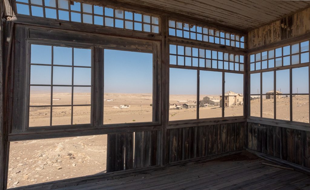 Ghost Town Framed By Windows With Broken Glass