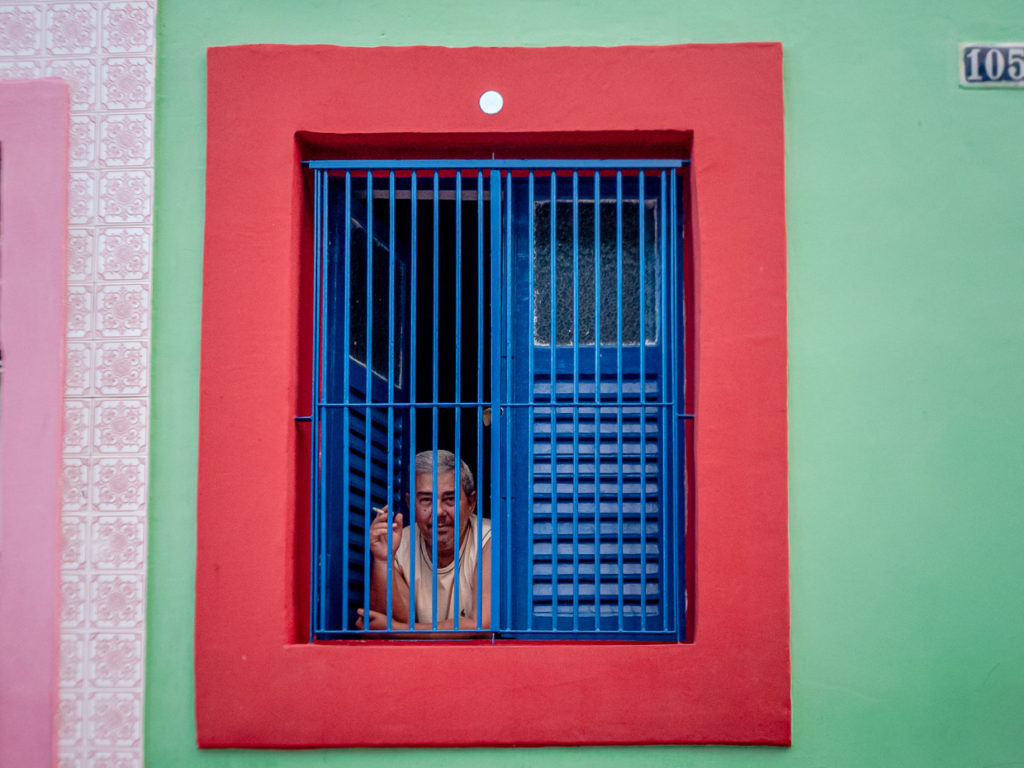 Man Smoking in Colorful Windowsill Olinda