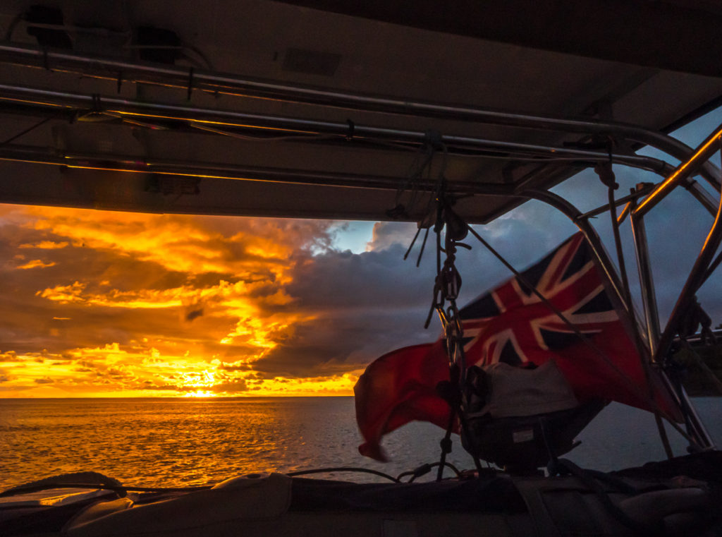 View from stern of boat at sunset with British ensign
