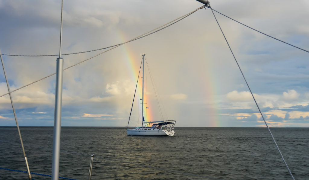 Sailboat with double rainbow