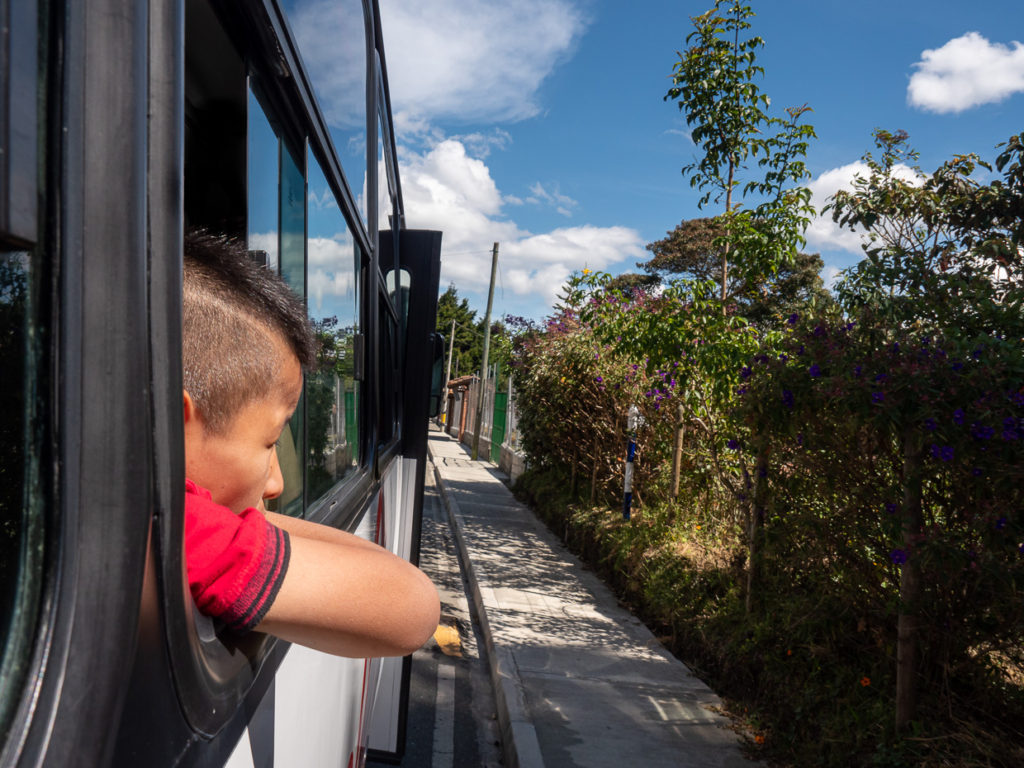 Young man riding modern bus looking out of window in Santa Elena  Colombia