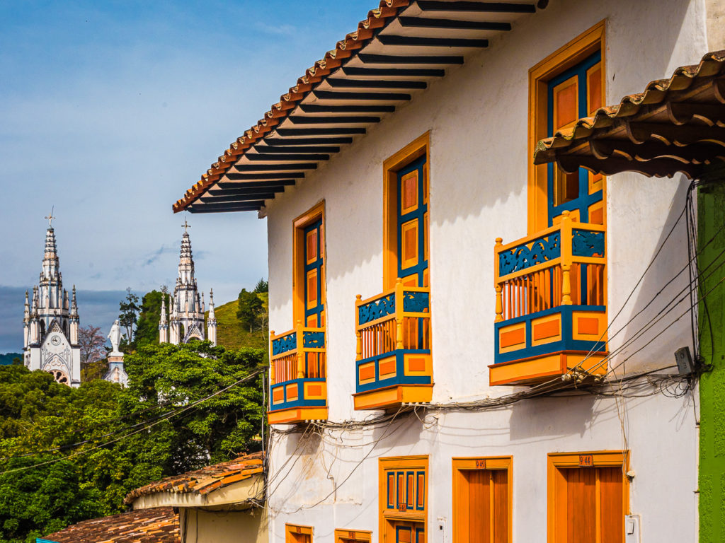 Santuario de Santa Laura Viewed Through Colorful Building in Jericó