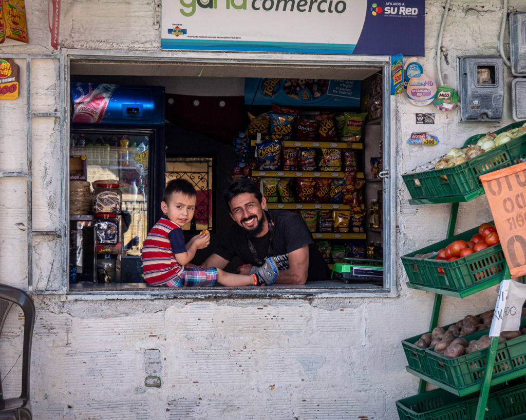Smiling Shop Keeper And Son in Miraflores, Medellín