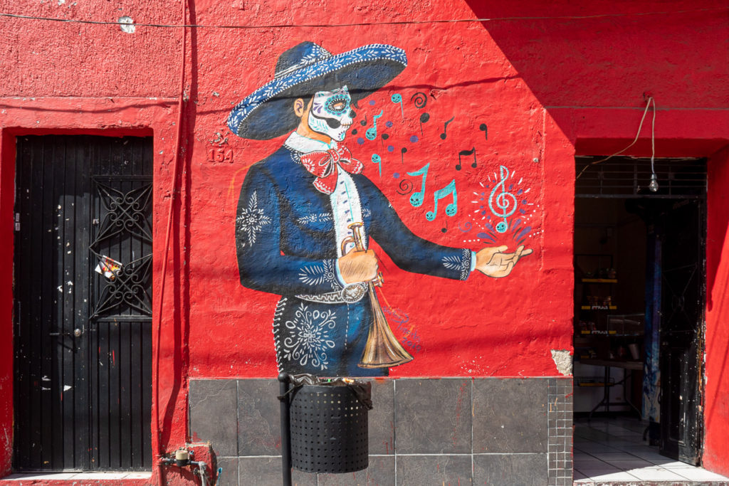Tlaquepaque street art featuring mariachi player wearing day of the dead mask