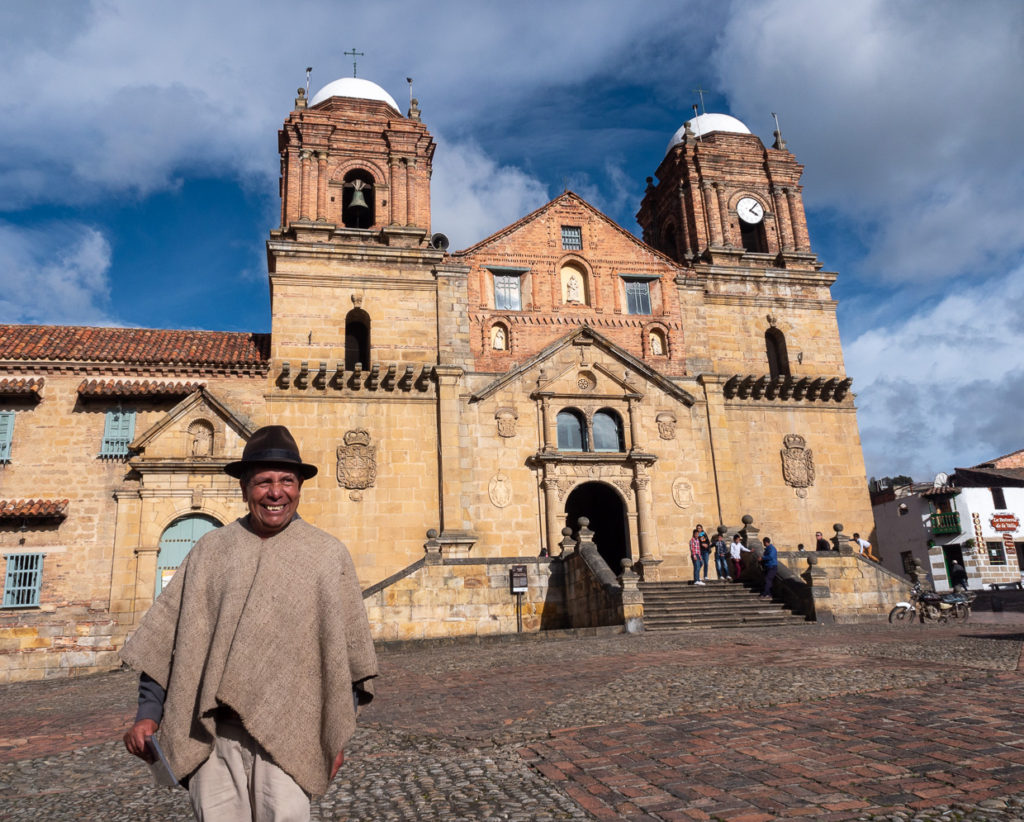 Man in poncho in front of Basilica de Nuestra Señora de Monguí 